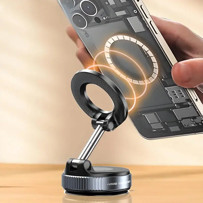 Phone ring light on a stand with smartphone held above, on a wooden surface.