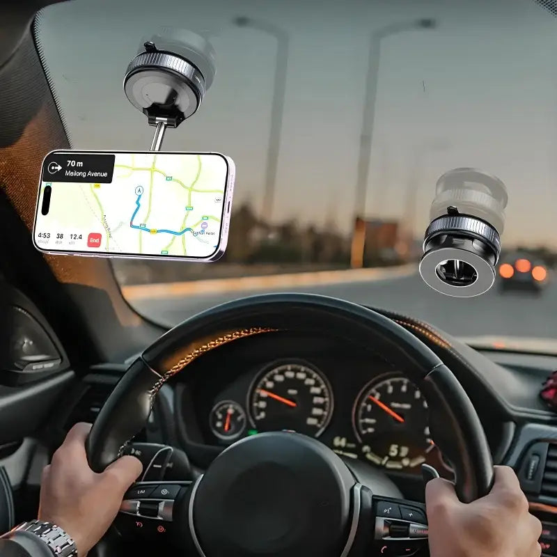 Car interior with a phone mount displaying a navigation app, streetlights outside.