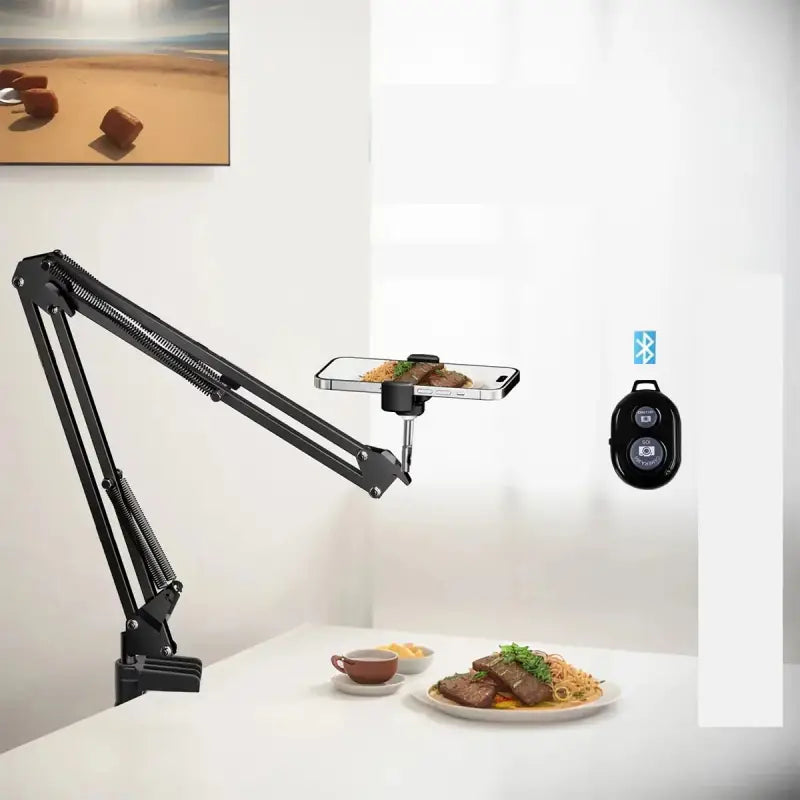 Adjustable phone holder with Bluetooth remote on a table with food