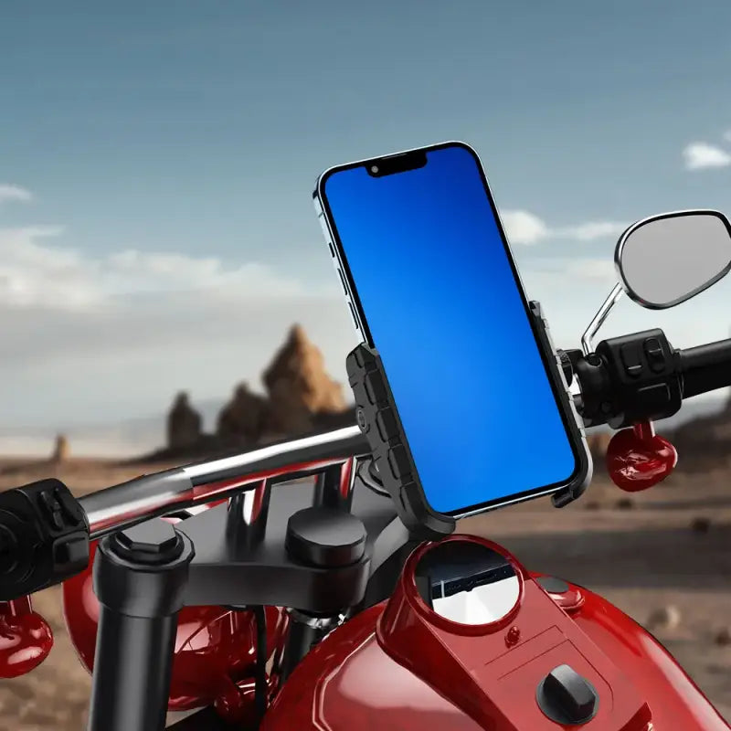 Phone mounted on a motorcycle handlebar with a desert landscape in the background