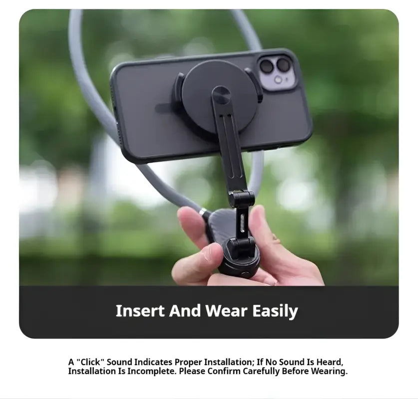 Hand holding a phone with a black clip and lanyard against a blurred green background
