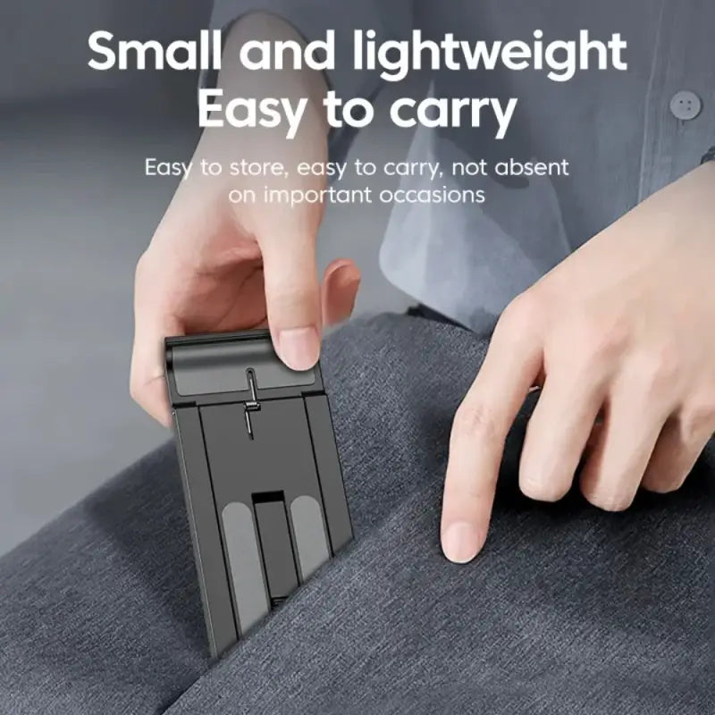 Person holding a small, black, compact device against a gray background with text about its portability.